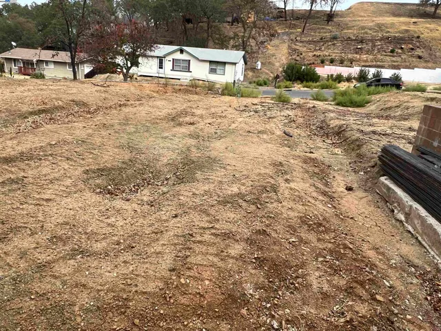 a white building with a yard covered in it