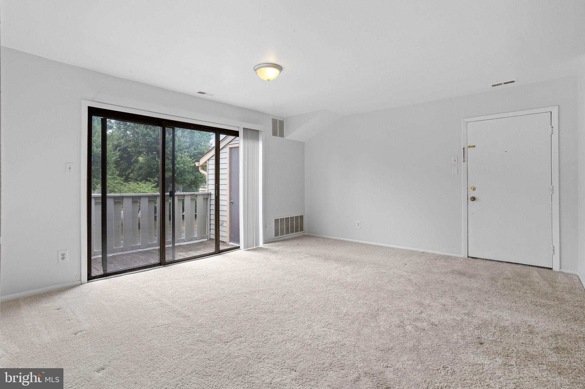 2010 Raven's Row Marlton, NJ 08053 - Photo 4 of 21 a view of an empty room with a sliding door