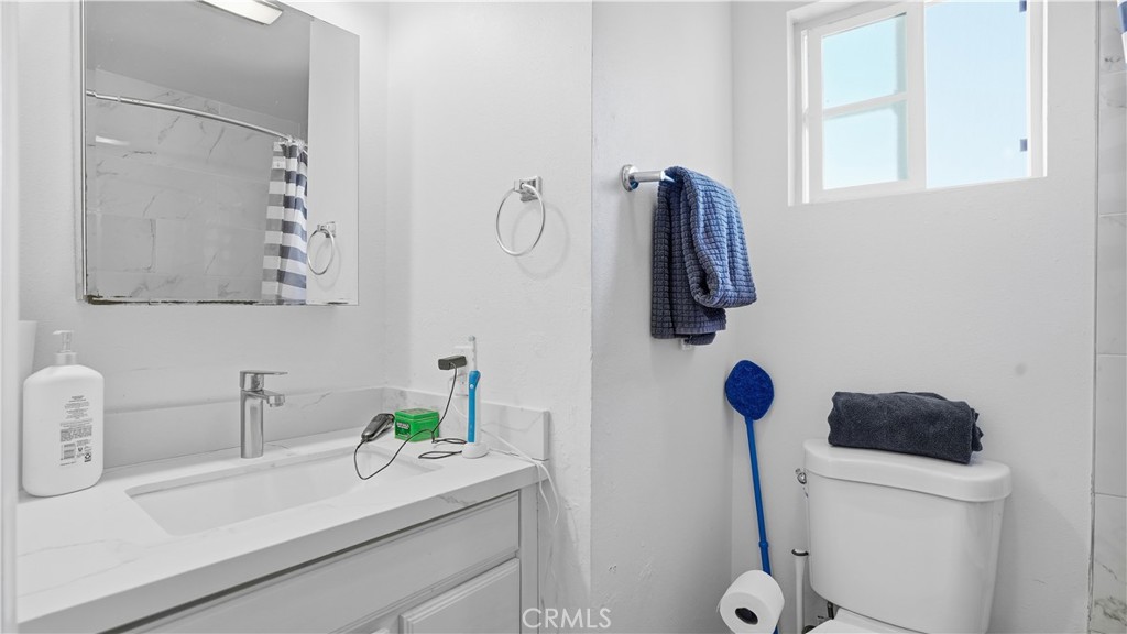 3599 Nina Street Oceanside, CA 92056 - Photo 15 of 32 a bathroom with a sink and mirror