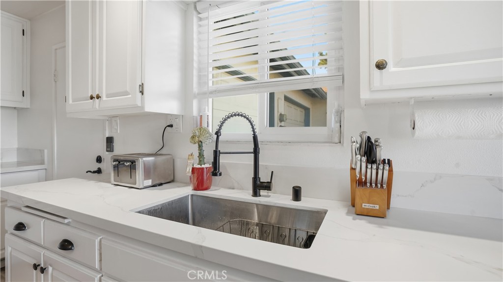 3599 Nina Street Oceanside, CA 92056 - Photo 9 of 32 a kitchen with a sink and a refrigerator