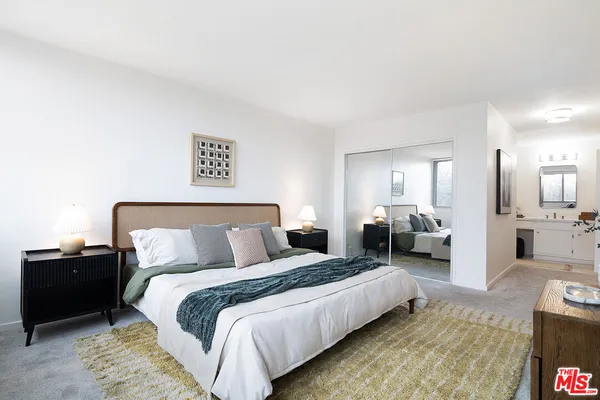 a spacious bedroom with a bed and a couch