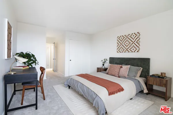 a bedroom with a bed and a chair
