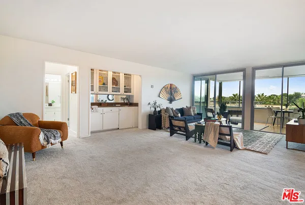a living room filled with furniture and a large window