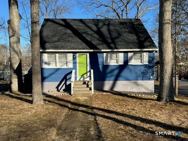 a view of a house with a wooden fence