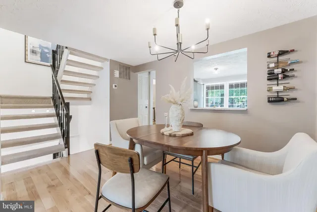 a view of a dining room with furniture and a chandelier
