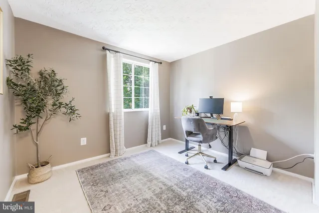 a workspace with furniture and a potted plant
