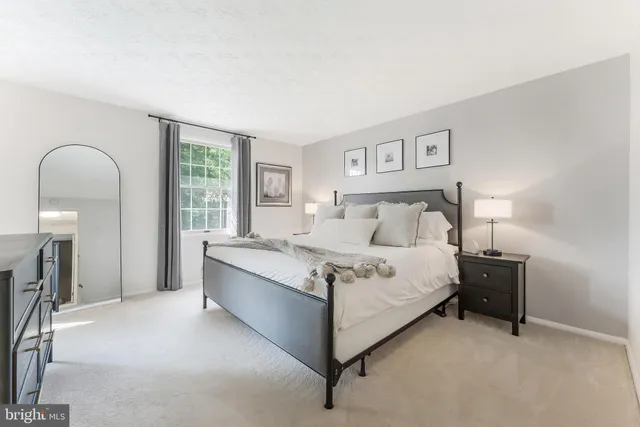 a bed room with a bed and a night stand