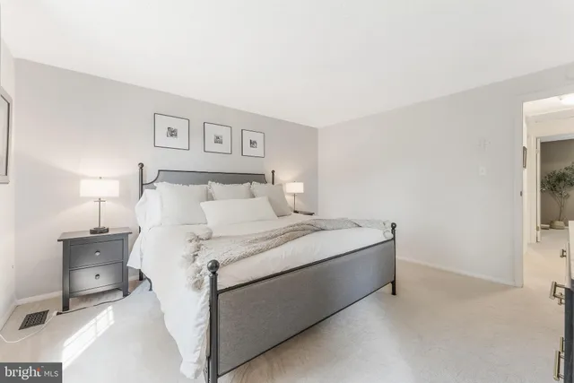 a room with a bed and a night stand