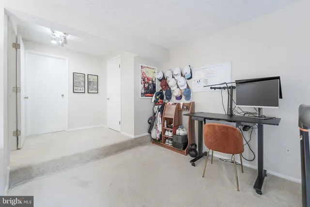 a view of a livingroom with wooden floor and furniture