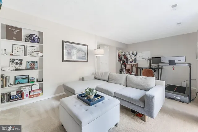 a storage room with stainless steel appliances kitchen island granite countertop lots of clutter