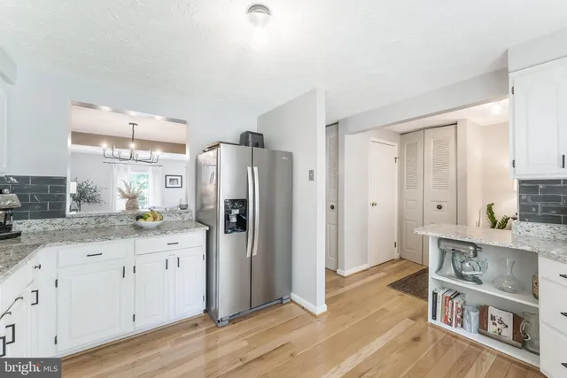 a kitchen with stainless steel appliances a refrigerator sink and cabinets