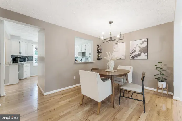 a view of a dining room with furniture wooden floor and chandelier