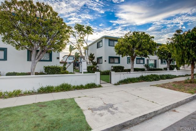 a view of a white house with a yard