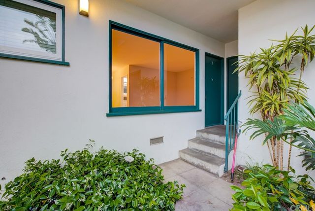 a kitchen with stainless steel appliances granite countertop a sink a refrigerator and a window