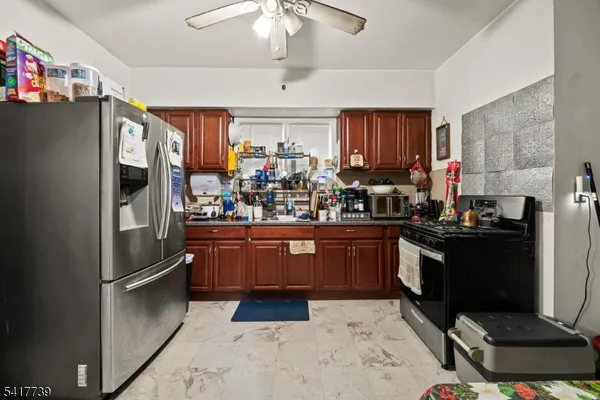 a kitchen with stainless steel appliances granite countertop a refrigerator a stove a sink and dishwasher