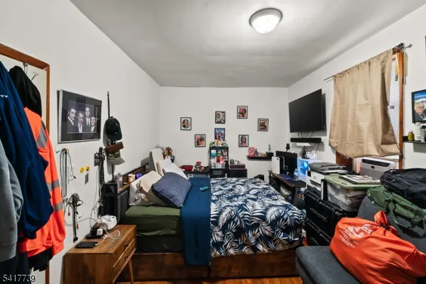 a bed room with furniture and a flat screen tv