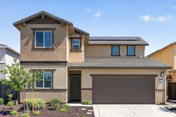a front view of a house with garage