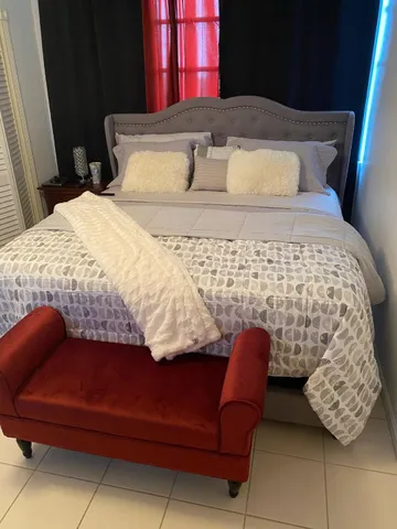 a bedroom with a bed and window