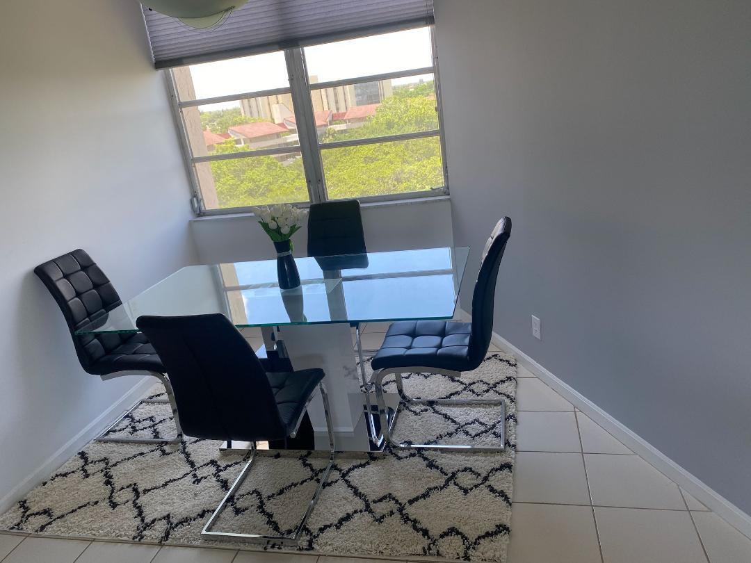 6921 Environ Boulevard, Unit 7N Lauderhill, FL 33319 - Photo 8 of 11 a view of a dining room with furniture and wooden floor