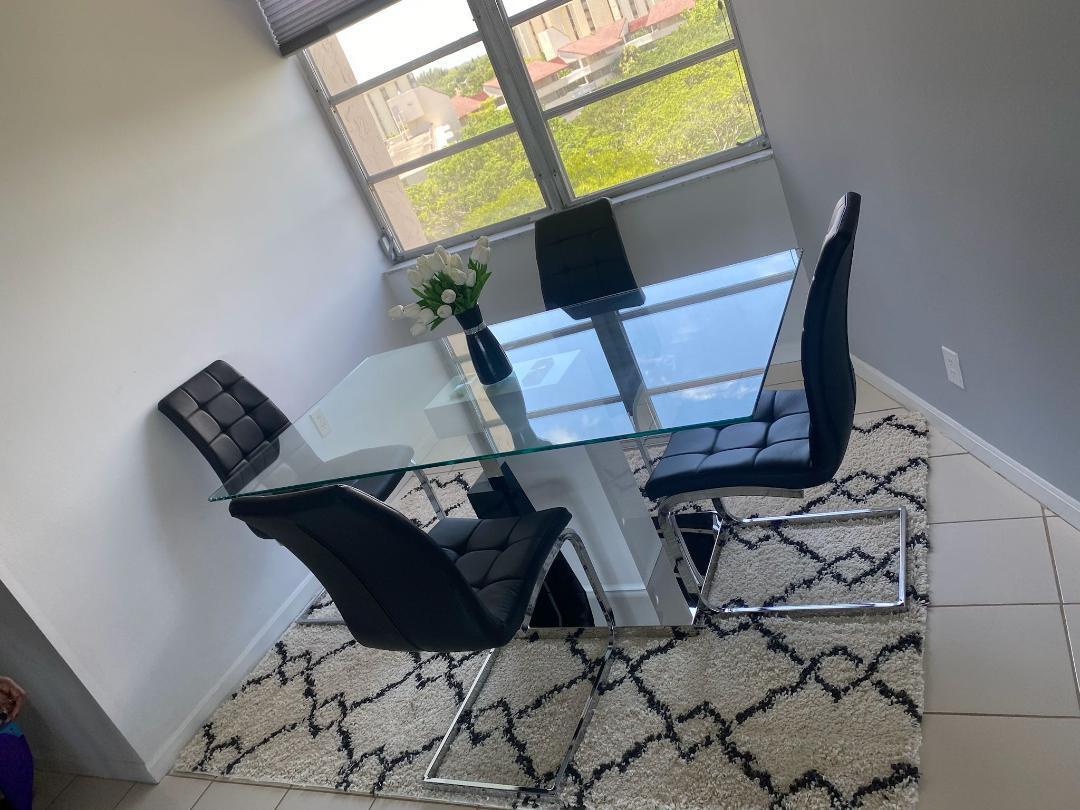 6921 Environ Boulevard, Unit 7N Lauderhill, FL 33319 - Photo 9 of 11 a living room with chairs and a window