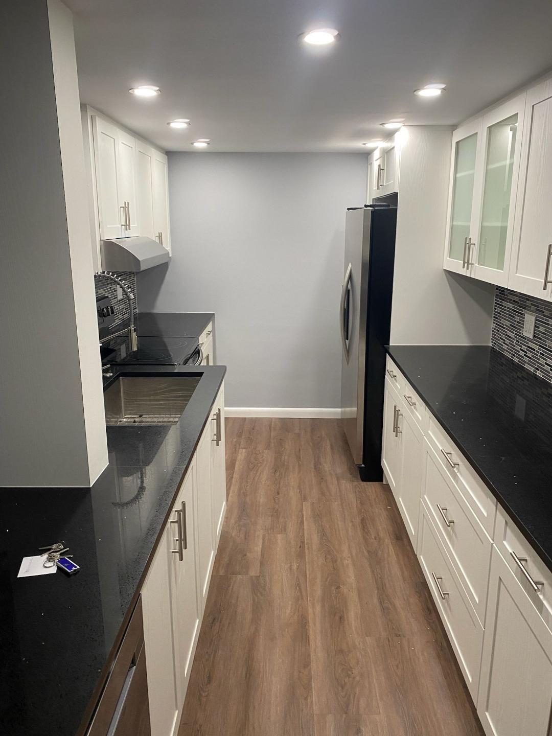 6921 Environ Boulevard, Unit 7N Lauderhill, FL 33319 - Photo 10 of 11 a kitchen with granite countertop a sink stove and refrigerator