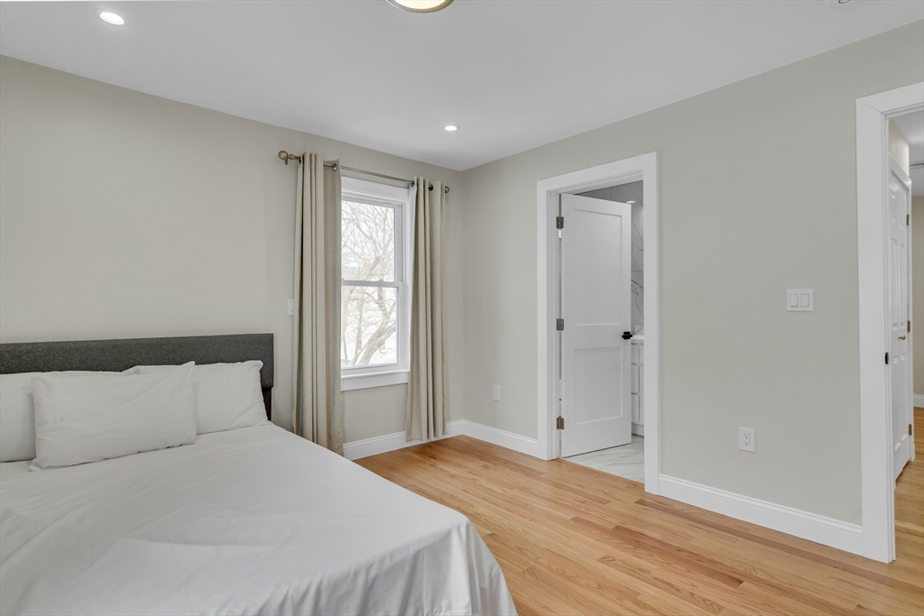 52 Holyoke Street, Unit 2 Quincy, MA 02171 - Photo 12 of 25 a bedroom with a bed and a window