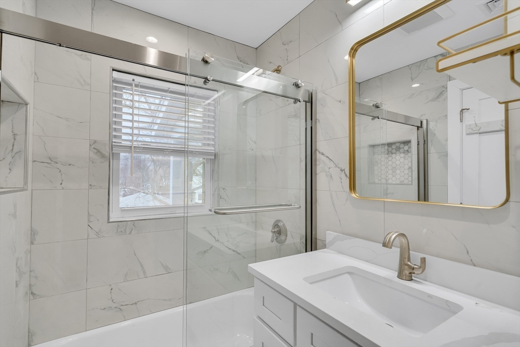 52 Holyoke Street, Unit 2 Quincy, MA 02171 - Photo 13 of 25 a bathroom with a sink and a mirror