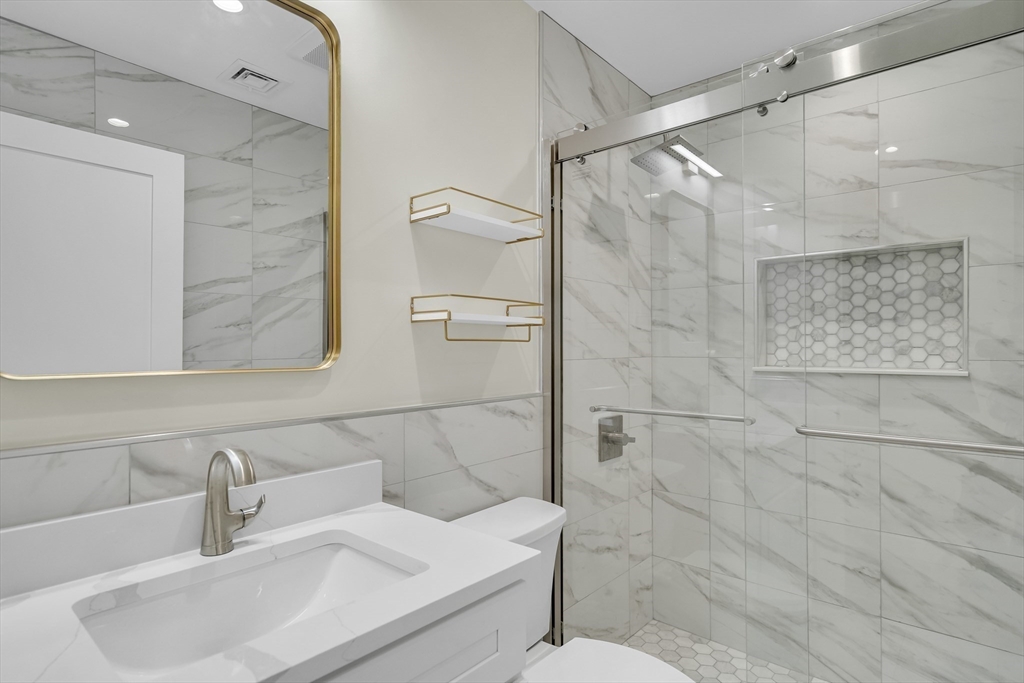 52 Holyoke Street, Unit 2 Quincy, MA 02171 - Photo 16 of 25 a bathroom with a sink shower and a mirror