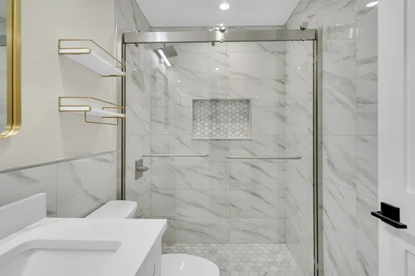 a bathroom with a shower and toilet