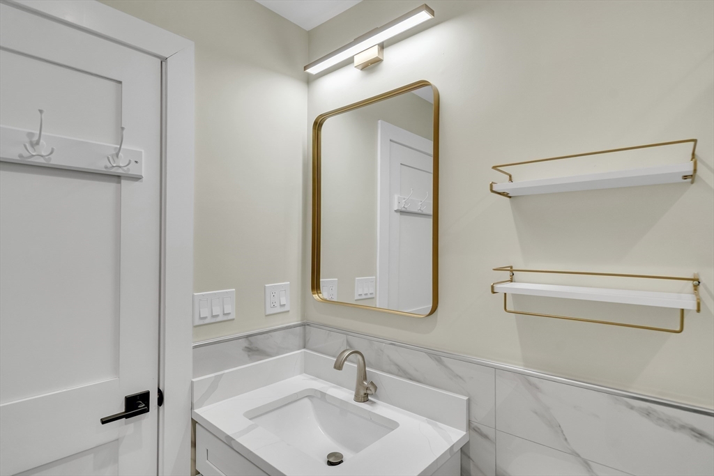 52 Holyoke Street, Unit 2 Quincy, MA 02171 - Photo 18 of 25 a bathroom with a sink and a mirror