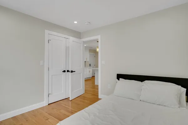 a bedroom with a bed and a painting on the wall