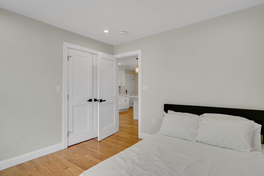 52 Holyoke Street, Unit 2 Quincy, MA 02171 - Photo 19 of 25 a bedroom with a bed and a painting on the wall