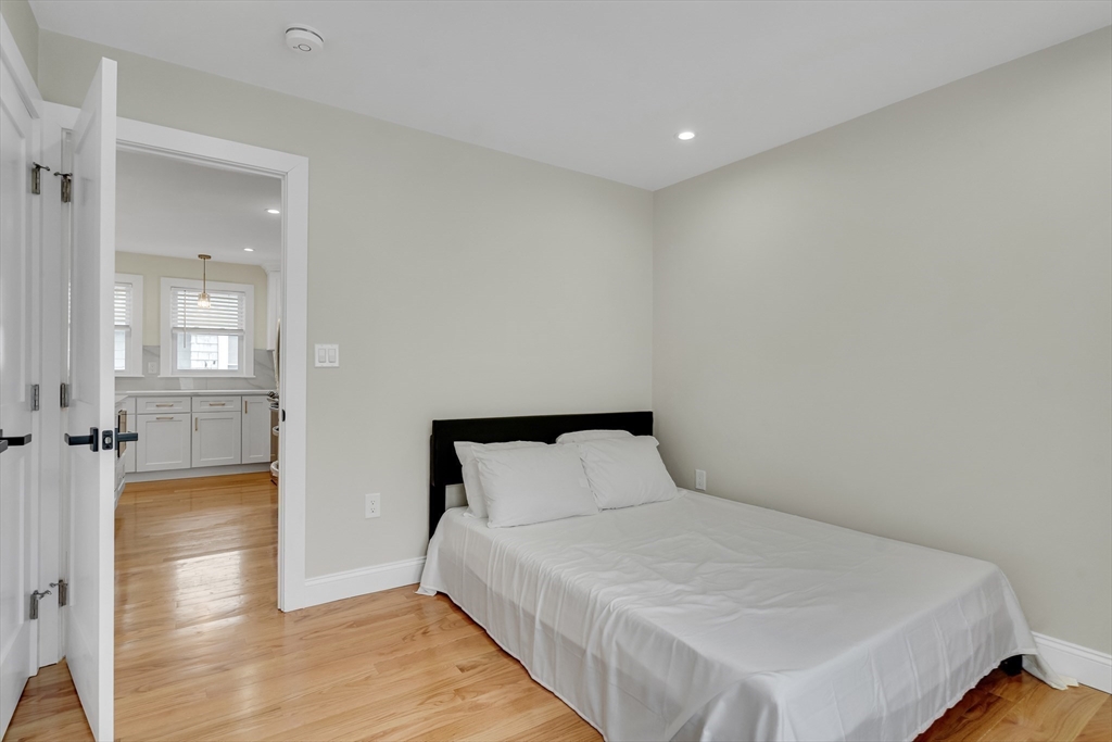 52 Holyoke Street, Unit 2 Quincy, MA 02171 - Photo 20 of 25 a bedroom with a bed and glass door