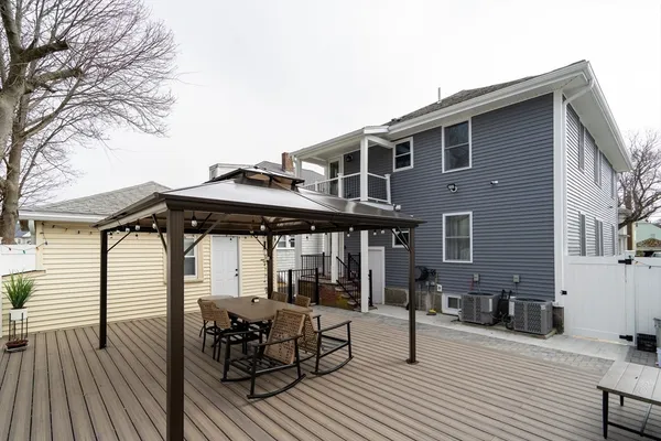 a view of a house with backyard and sitting area