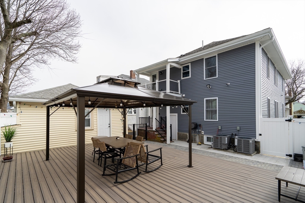 52 Holyoke Street, Unit 2 Quincy, MA 02171 - Photo 22 of 25 a view of a chairs and table on the wooden floor in front of house