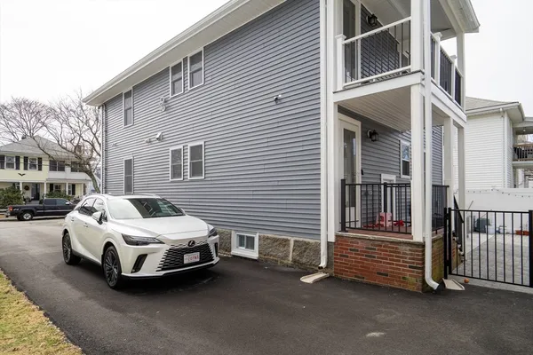 a view of a house with backyard and sitting area