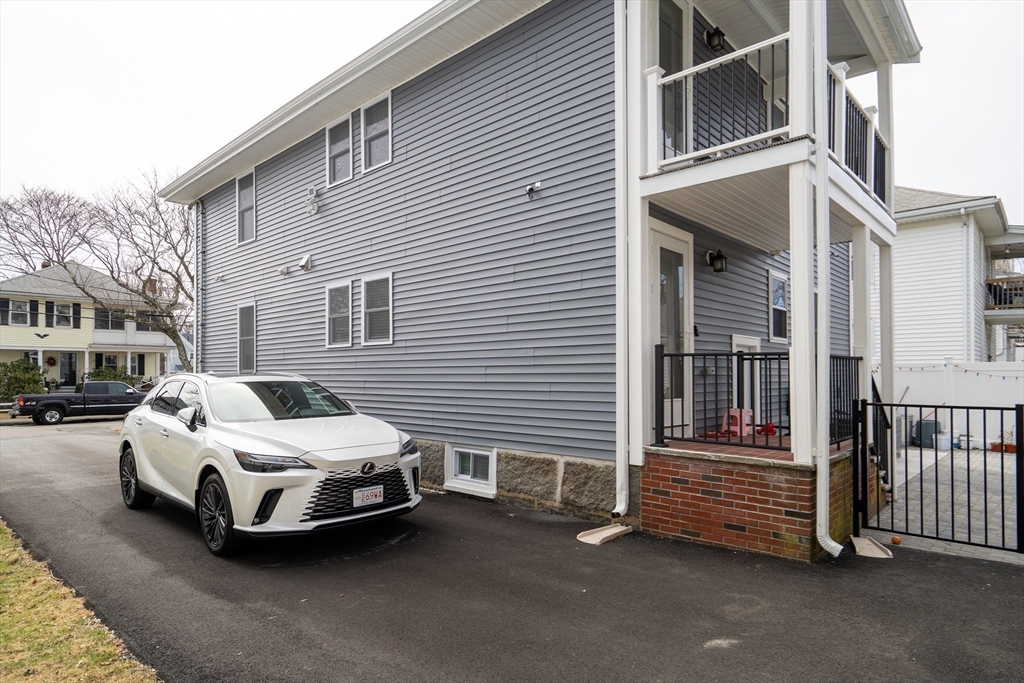 52 Holyoke Street, Unit 2 Quincy, MA 02171 - Photo 24 of 25 a car parked in front of a white house