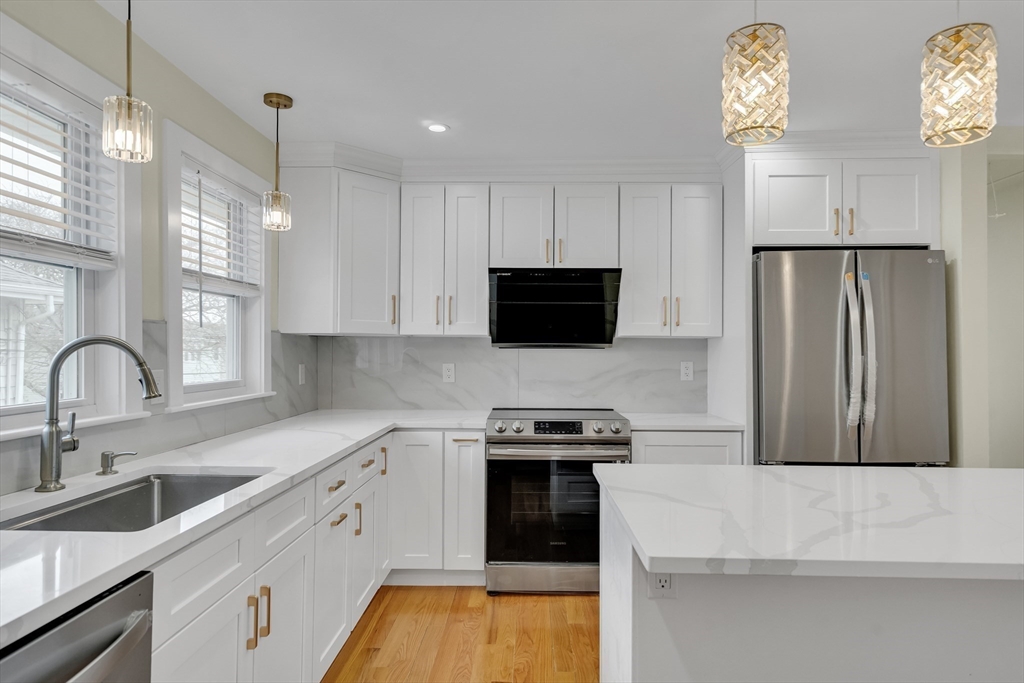 52 Holyoke Street, Unit 2 Quincy, MA 02171 - Photo 7 of 25 a kitchen with a sink a stove and refrigerator