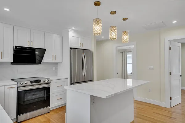 a kitchen with stainless steel appliances a stove microwave and a refrigerator