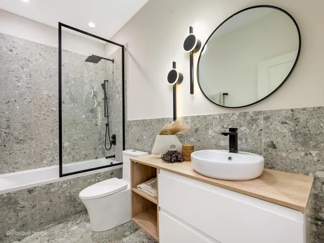 a bathroom with a sink a toilet and a mirror