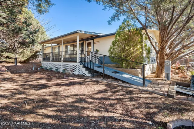 a view of a house with a yard covered in snow