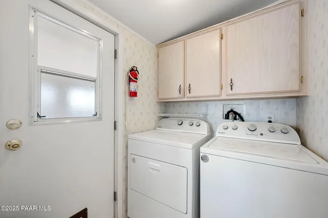 a view of storage and utility room with washer and dryer