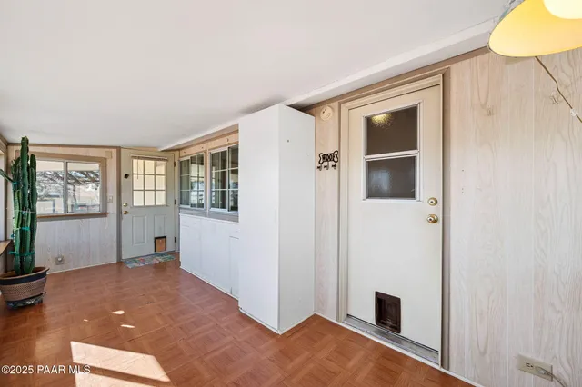 a view of a livingroom with wooden floor and cabinet