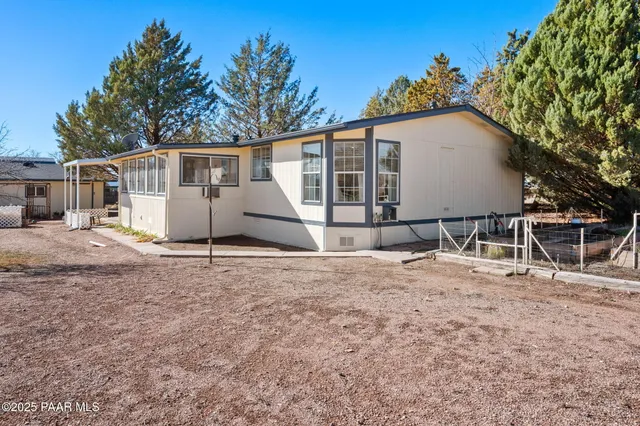 a view of a house with wooden fence