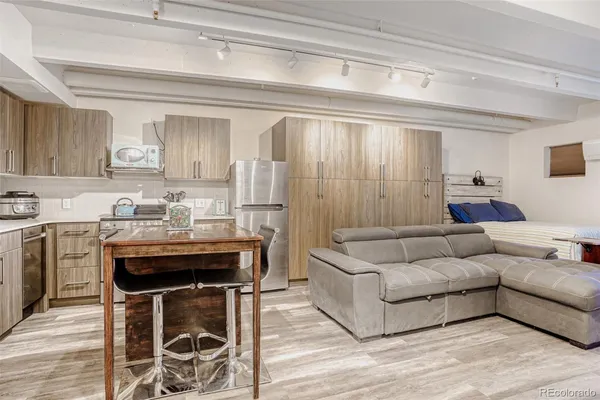 a living room with furniture and a wooden floor