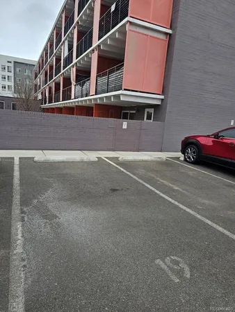 a view of a building with car parked