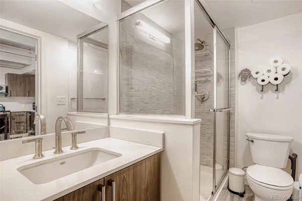 a bathroom with a sink toilet and shower