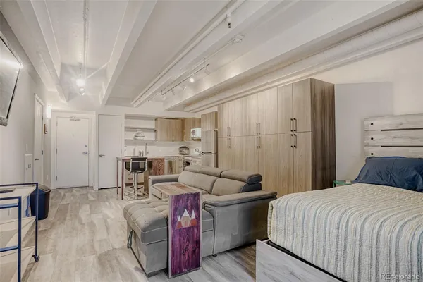 a bedroom with furniture and a wooden floor