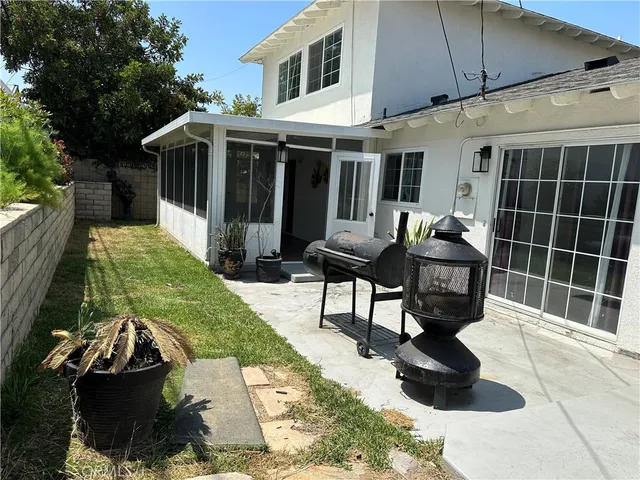 a view of a house with backyard and sitting area