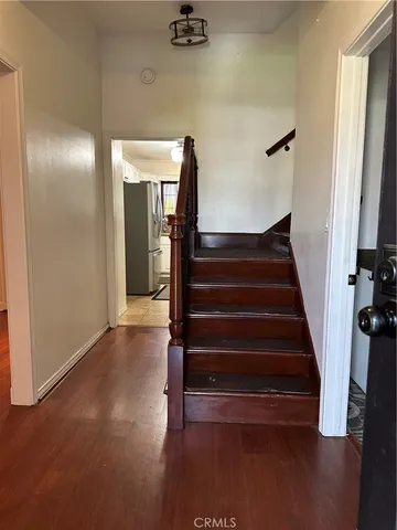 a view of entryway and hall with wooden floor